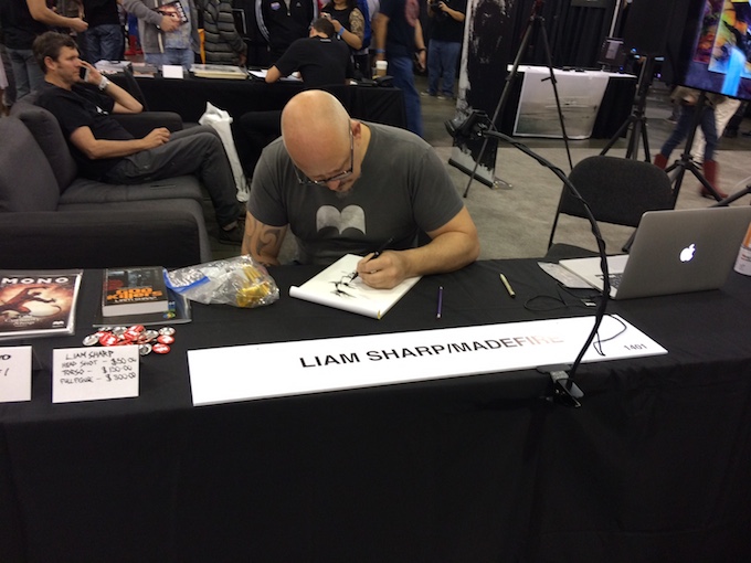 Liam Sharp sketching away while 30,000 visitors sweep through the Convention Center.